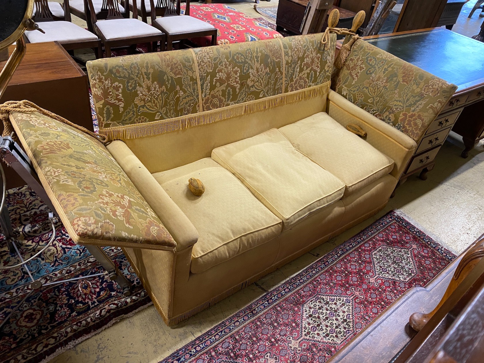 A Knole settee, upholstered in floral brocade, width 186cm, depth 80cm, height 104cm.